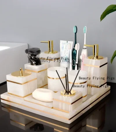 Natural marble golden soap dispenser on bathroom counter, soft lighting.