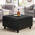 Goldoma modern black square storage ottoman with button tufting and wooden legs in a living room setting