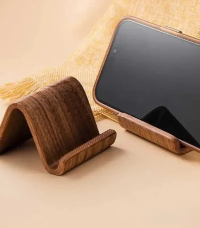 Black walnut phone stand with business card slot on a modern desk