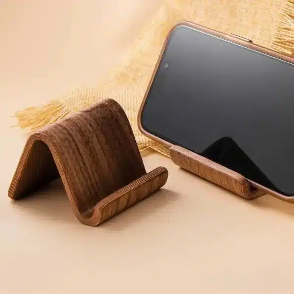 Black walnut phone stand with business card slot on a modern desk