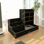 Wooden pen holder on a white desk, with colorful pens arranged by color in the slots.