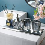 Glass soap dispenser with gold accents.