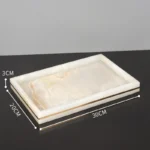 Toothbrush holder in marble gold, front view.