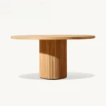 French retro oval dining table with natural wood top and teak base in a dining room setting