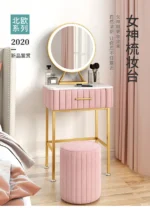 Marble top dressing table with lighted mirror and stool in a bedroom setting