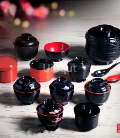 Japanese style ramen bowl set with melamine bowls, spoons, and noodle cups on a table