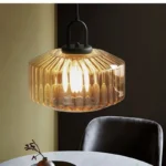 Modern colored glass pendant lamp illuminating a cozy dining room with vibrant hues