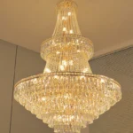 Modern crystal chandelier for dining room hanging over a wooden table with warm glow