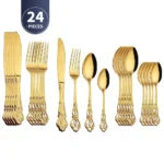 Gold flatware set with spoon, fork, and steak knife on a white tablecloth