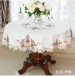 Elegant lace tablecloth with rose gold embroidery on a dining table