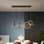 Black modern pendant light with a sleek cylindrical shade above a dining set.