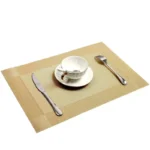 Gold weave placemats on a dining table with plates and cutlery