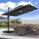 Goldoma large patio umbrella with lights illuminating a 9x9 FT square cantilever umbrella with solar LED lights in a bac