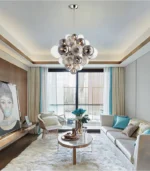 Smoky gray chandelier with glass bubbles hanging over a modern dining table