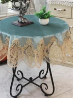 Elegant lace tablecloth with rose gold embroidery on a dining table