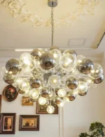 Smoky gray chandelier with glass bubbles hanging over a modern dining table