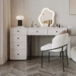 Modern minimalist makeup vanity table with mirror and stool in a bedroom setting