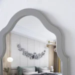 Modern white dressing table with mirror and stool in a bedroom setting