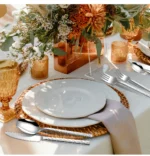 30-piece stainless steel flatware set with mirror finish on wooden table