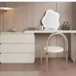 Modern vanity table with mirror and drawers in a bedroom setting