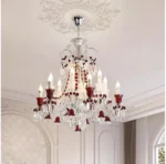 Modern red crystal chandelier with clear red K9 crystals hanging in a living room