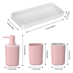 Matching pink wash cup with gold rim, placed beside the soap dispenser.