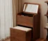 Wooden makeup vanity with mirror and stool in a modern bedroom setting