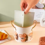 4-grid iron kitchen utensil storage box with chopsticks, spoons, and forks neatly organized on a countertop