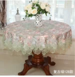 Elegant lace tablecloth with rose gold embroidery on a dining table