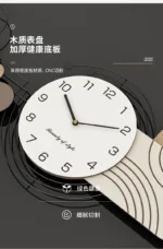 White clock with thin black hands against a navy blue wall in a study room.