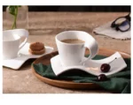 White porcelain espresso cup with wavy design on saucer, modern home decor