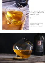 Rotating whiskey glass on a wooden table with amber liquid swirling inside