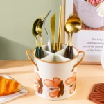 4-grid iron kitchen utensil storage box with chopsticks, spoons, and forks neatly organized on a countertop