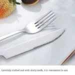 Stainless steel flatware set with wooden handles displayed on a table