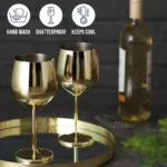 Set of 6 stainless steel wine glasses on a wooden table with red wine