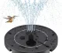 Outdoor bird bath fountain with solar panel and water spray in a garden
