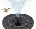Outdoor bird bath fountain with solar panel and water spray in a garden
