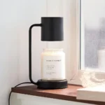 Dimmable candle warmer lamp illuminating a wax melt, creating a warm glow in a living room.