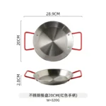 Stainless steel paella pan with double ears on a stove