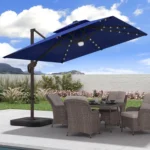 Goldoma large patio umbrella with lights illuminating a 9x9 FT square cantilever umbrella with solar LED lights in a bac