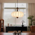 Walnut wood chandelier with fabric shades in a cozy living room
