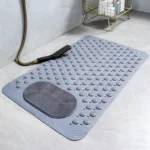 Oblong non-slip bath mat with suction cups on shower floor