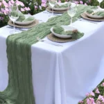 Boho cheesecloth table runner and napkins set as rustic table linens on a wooden table