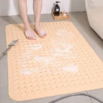 Non slip bath mat with suction cups in a white bathroom