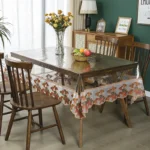 Elegant waterproof table protector with lace embroidery on a rectangular dining table