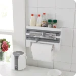 Goldoma wall mounted paper towel holder with storage rack and cutter in a modern kitchen