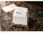 Close-up of the soap dispenser's pump mechanism, with gold accents on white porcelain.