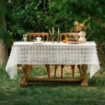 Retro polka dot tablecloth with fringe on a wooden table
