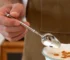 Set of 12 stainless steel forks arranged neatly on a wooden table