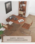 Nordic minimalist folding dining table with stainless steel telescopic extension in a modern living room setting